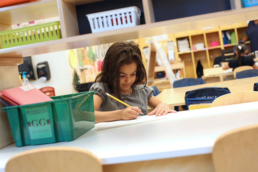 Young Child Writing in Class